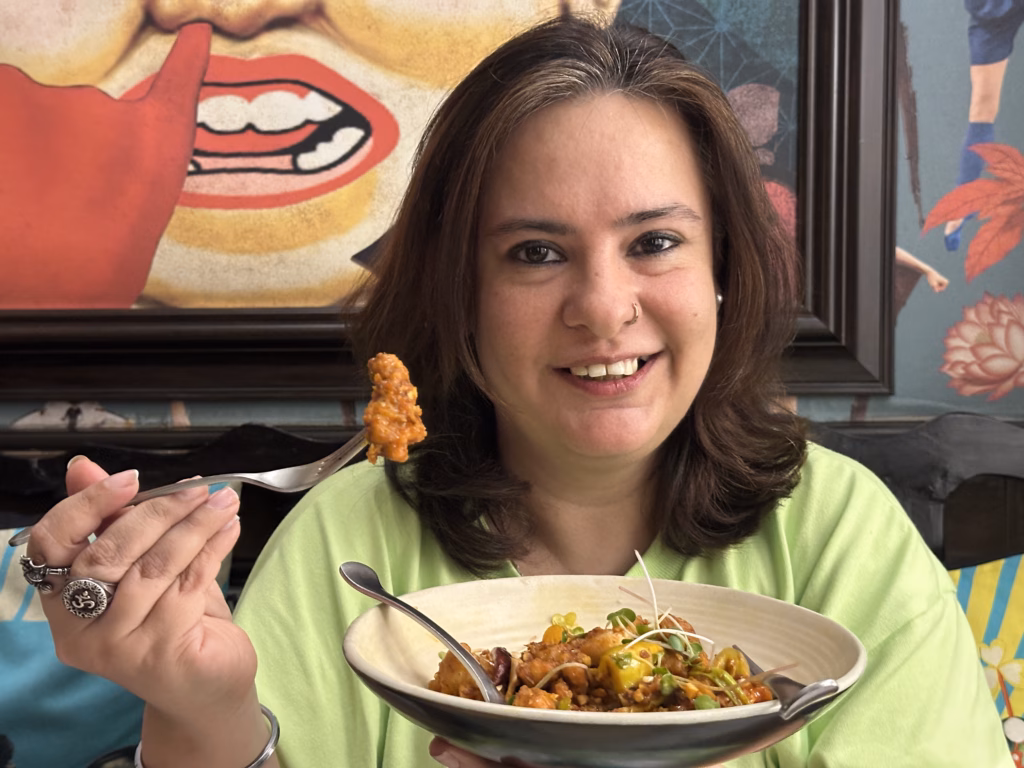 Ikreatepassions holding Chilly Chicken
